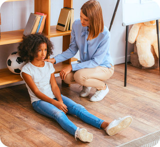 a female kid sitting with an adult woman